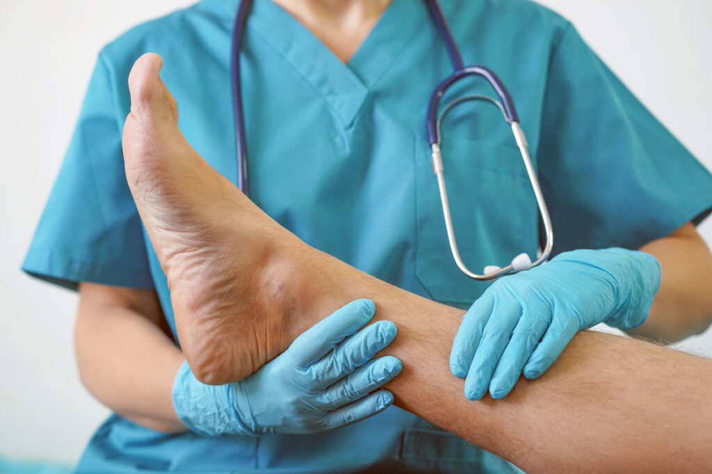 Hand of Doctor holding patient's leg, examination of patients in the hospital. Surgeon, surgical doctor, anesthetist holding leg patient's. Professional ER surgical, healthcare concept.